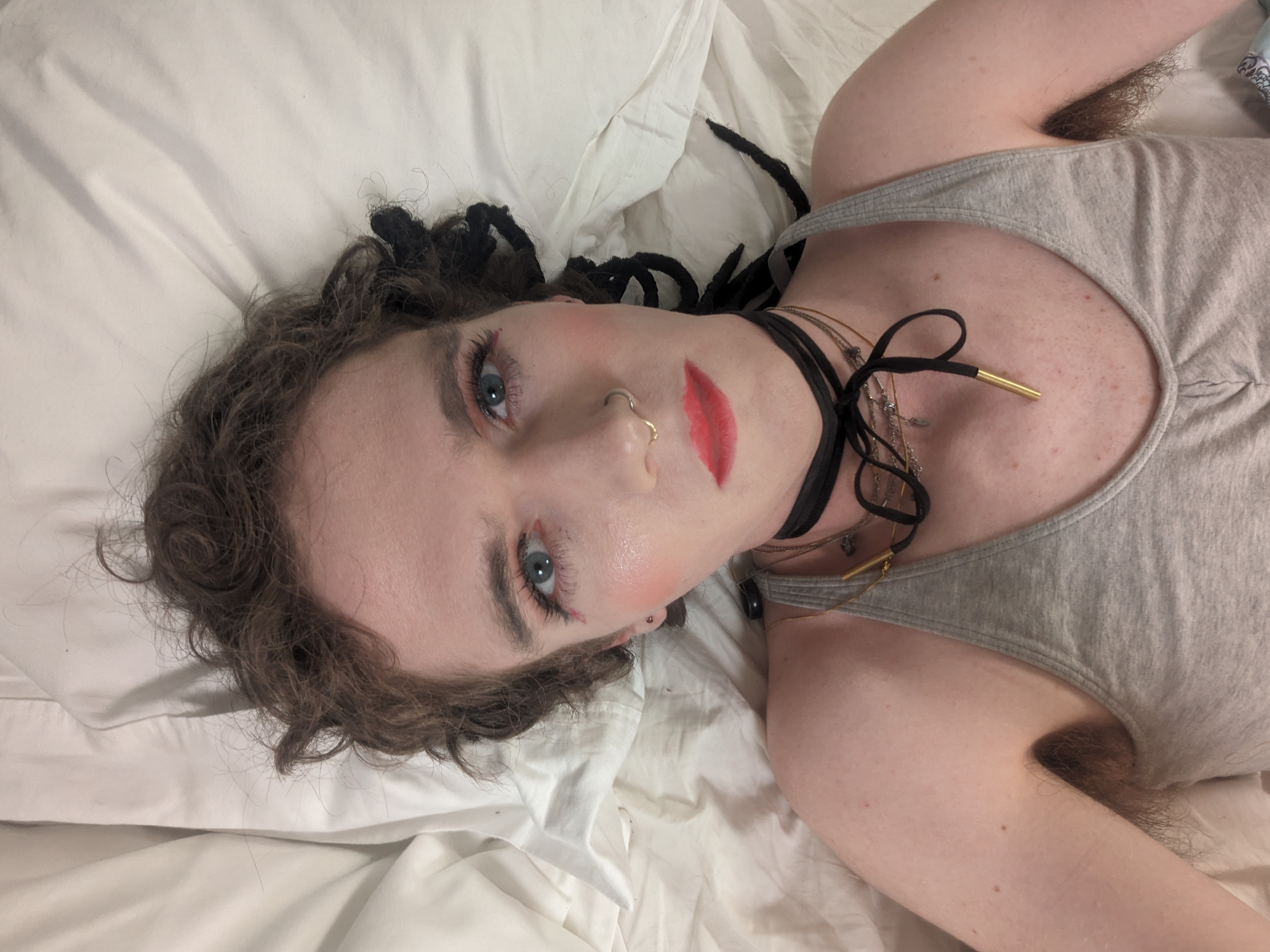 The photo shows a woman lying on a bed with white bedsheets. The... - by Daisy