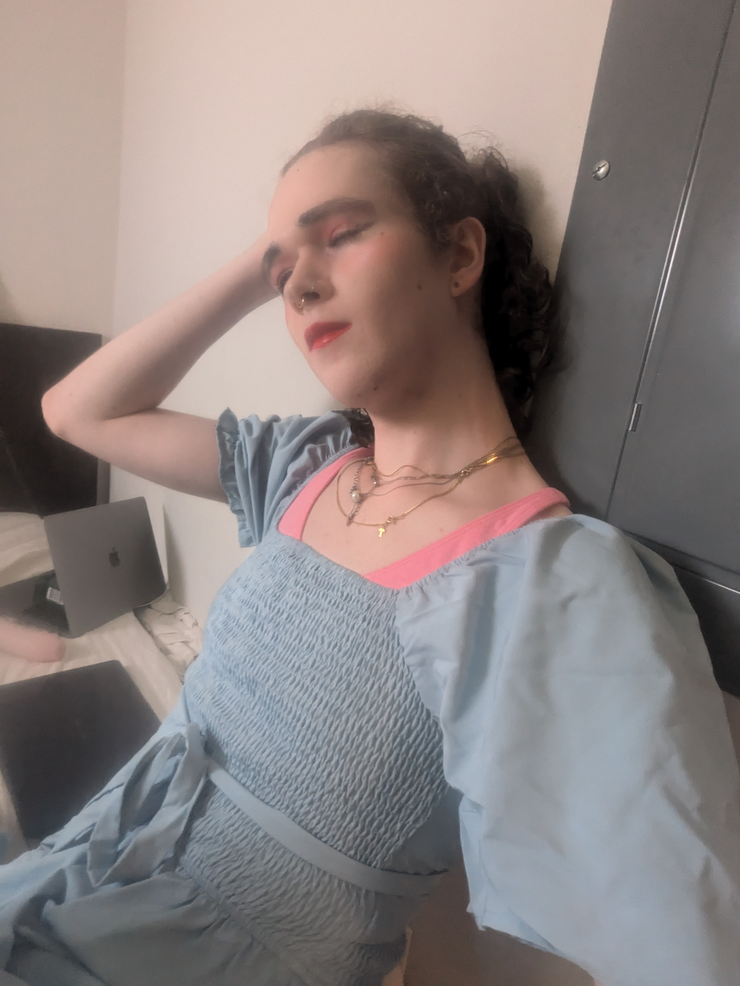 The photo shows a woman with curly hair tied back, wearing makeup... - by Daisy