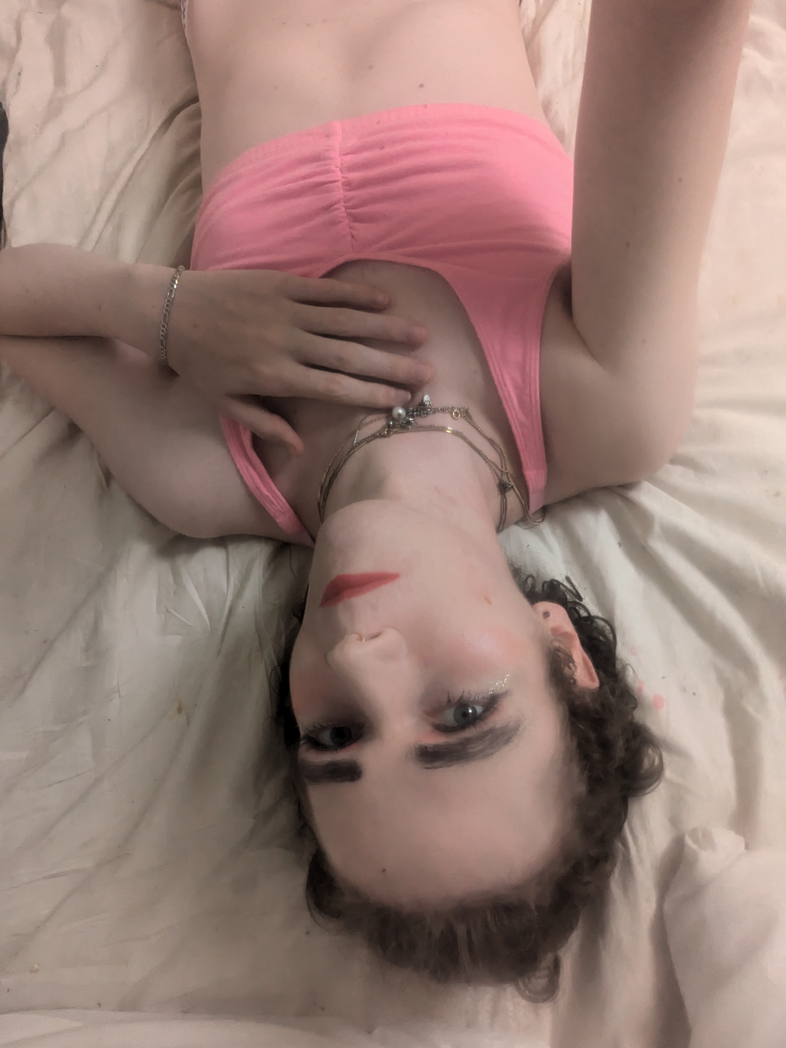 The photo shows a woman lying down on a light-colored surface,... - by Daisy