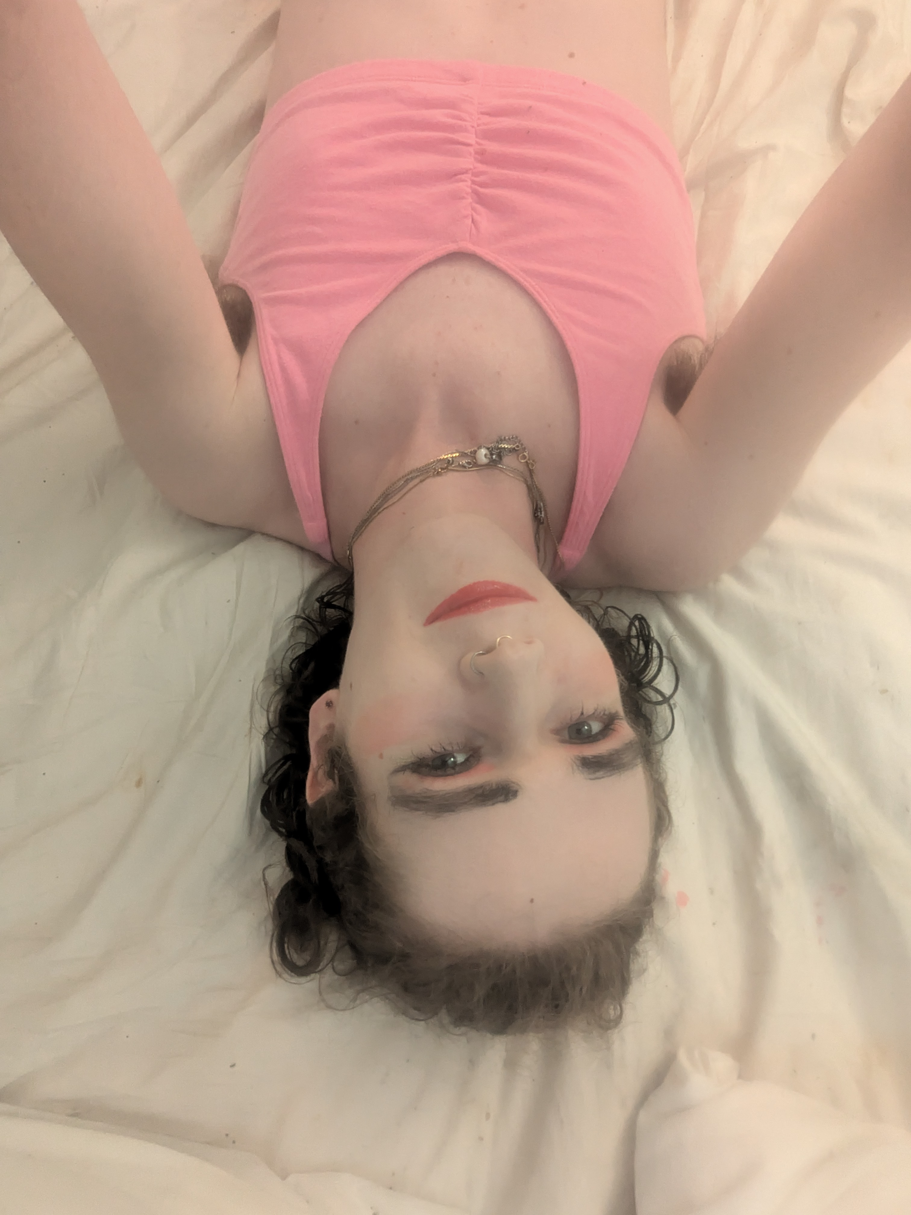 The photo shows a woman lying on her back on a bed with... - by Daisy