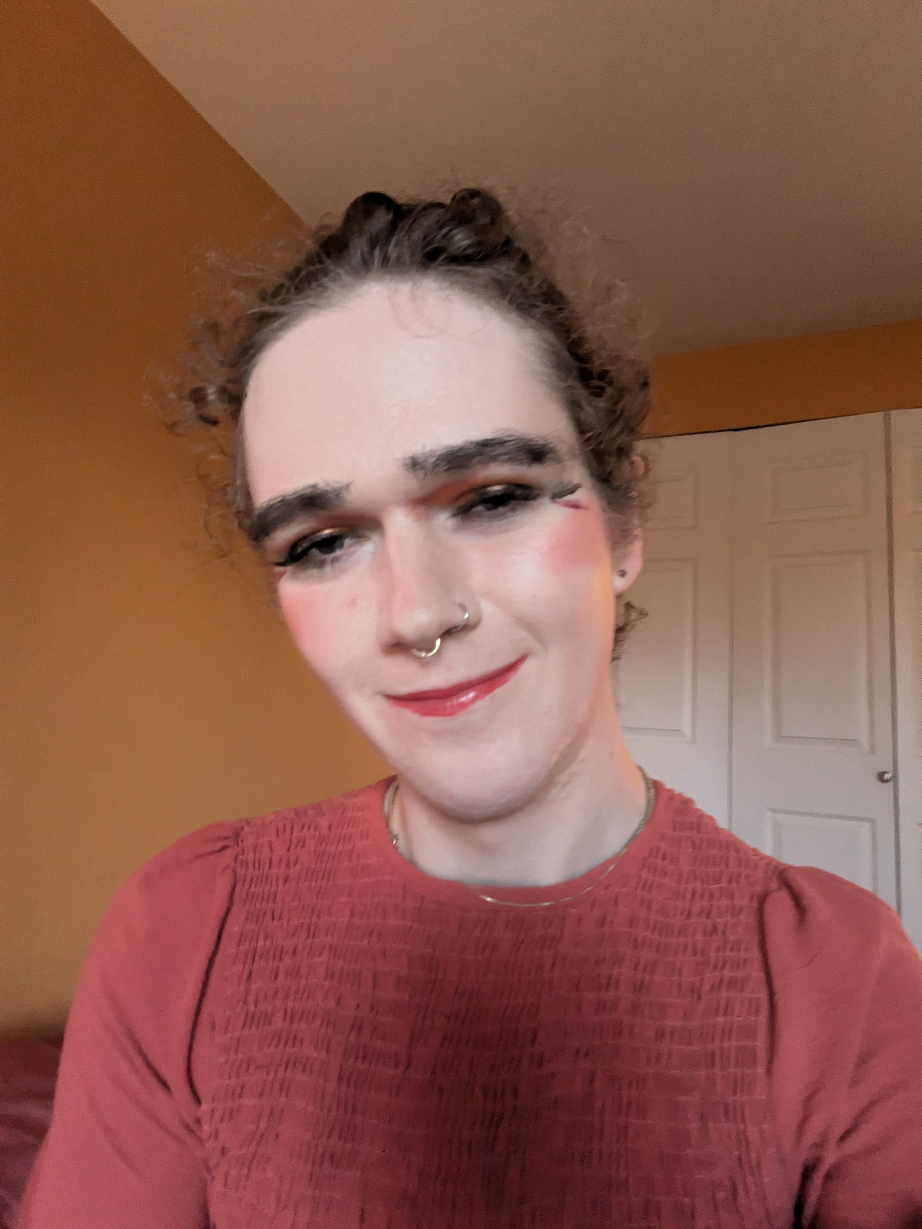 This photo shows a woman with curly hair wearing makeup, including... - by Daisy