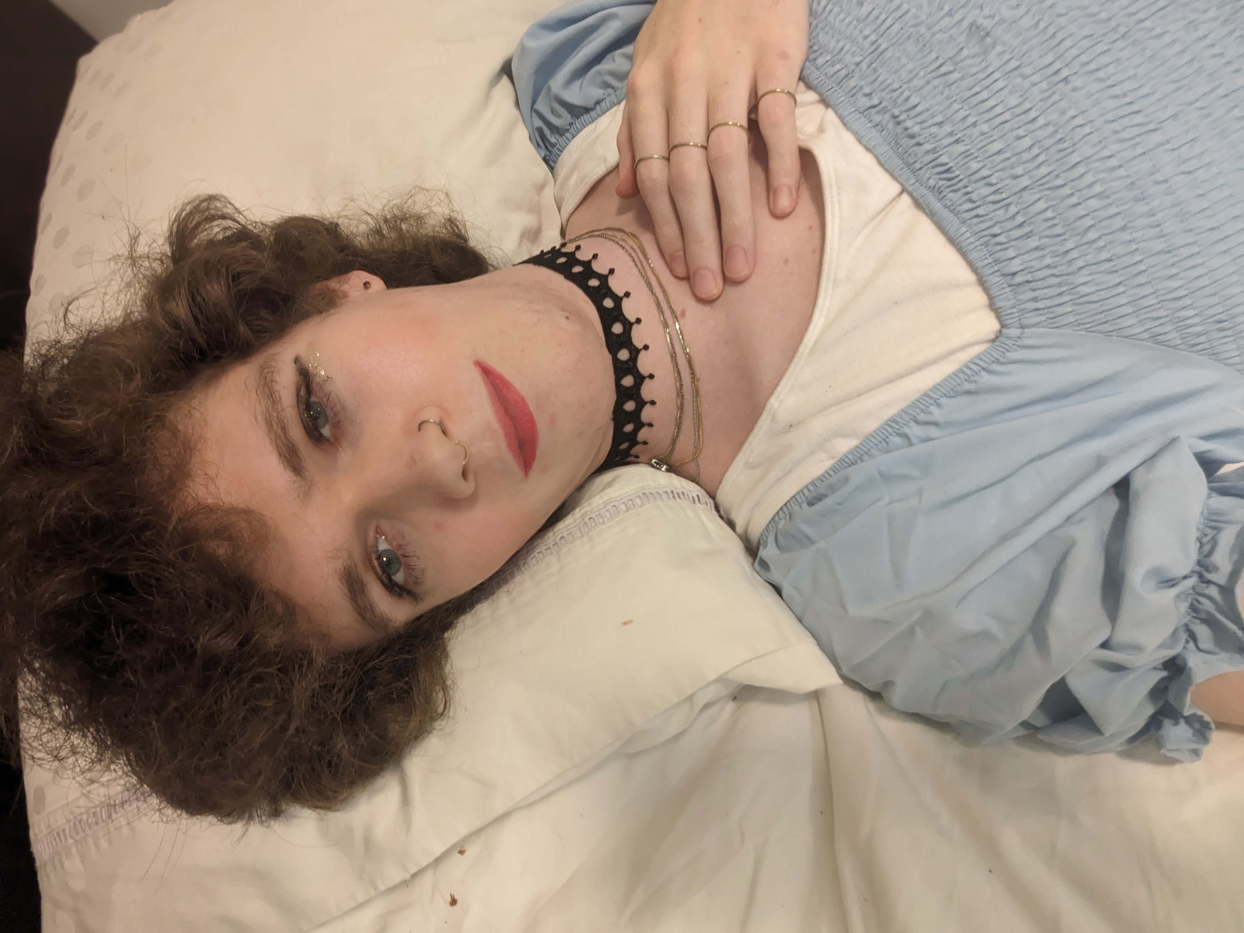 The photo shows a woman lying down on a bed with her head resting... - by Daisy