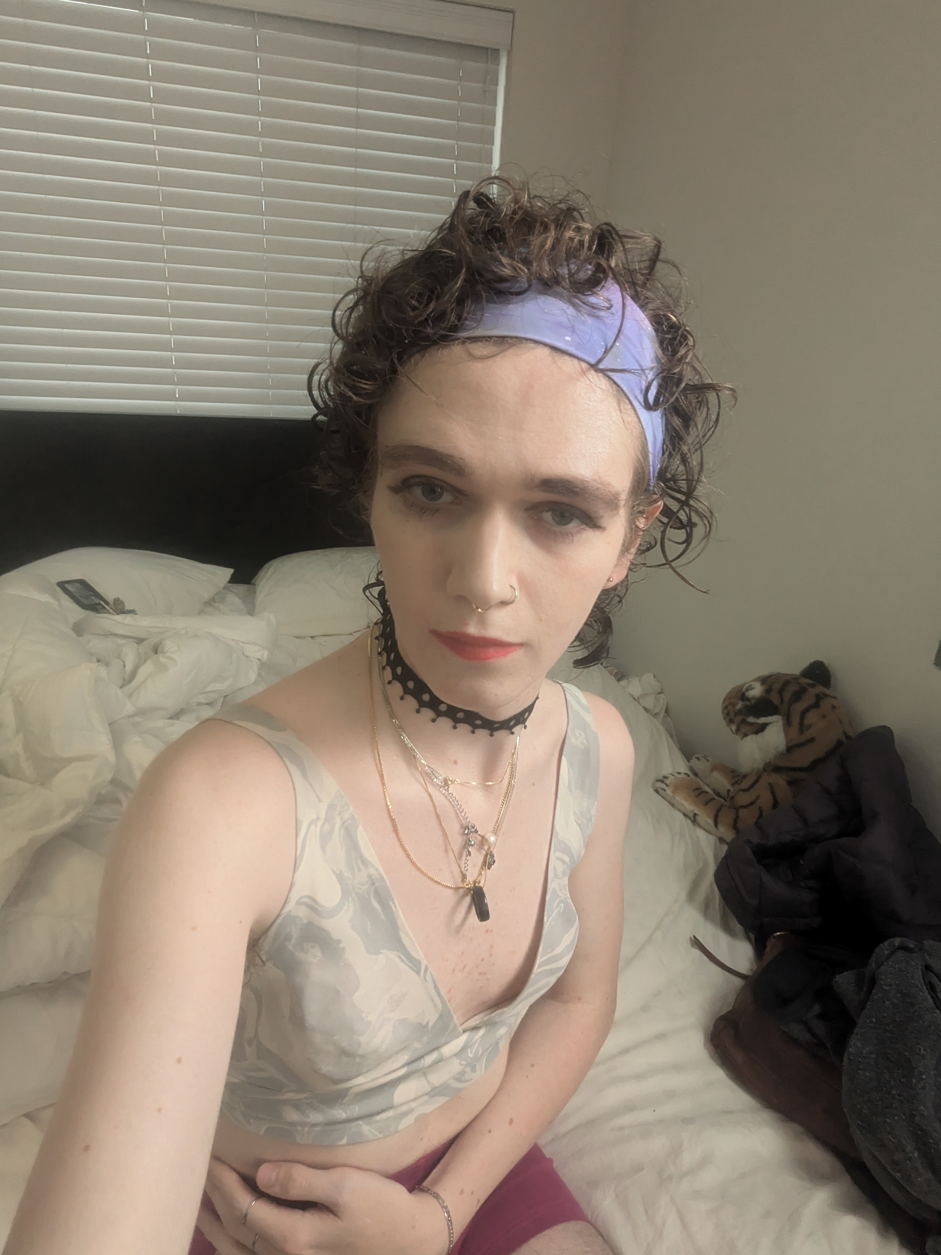 The photo shows a woman with curly hair wearing a light purple... - by Daisy