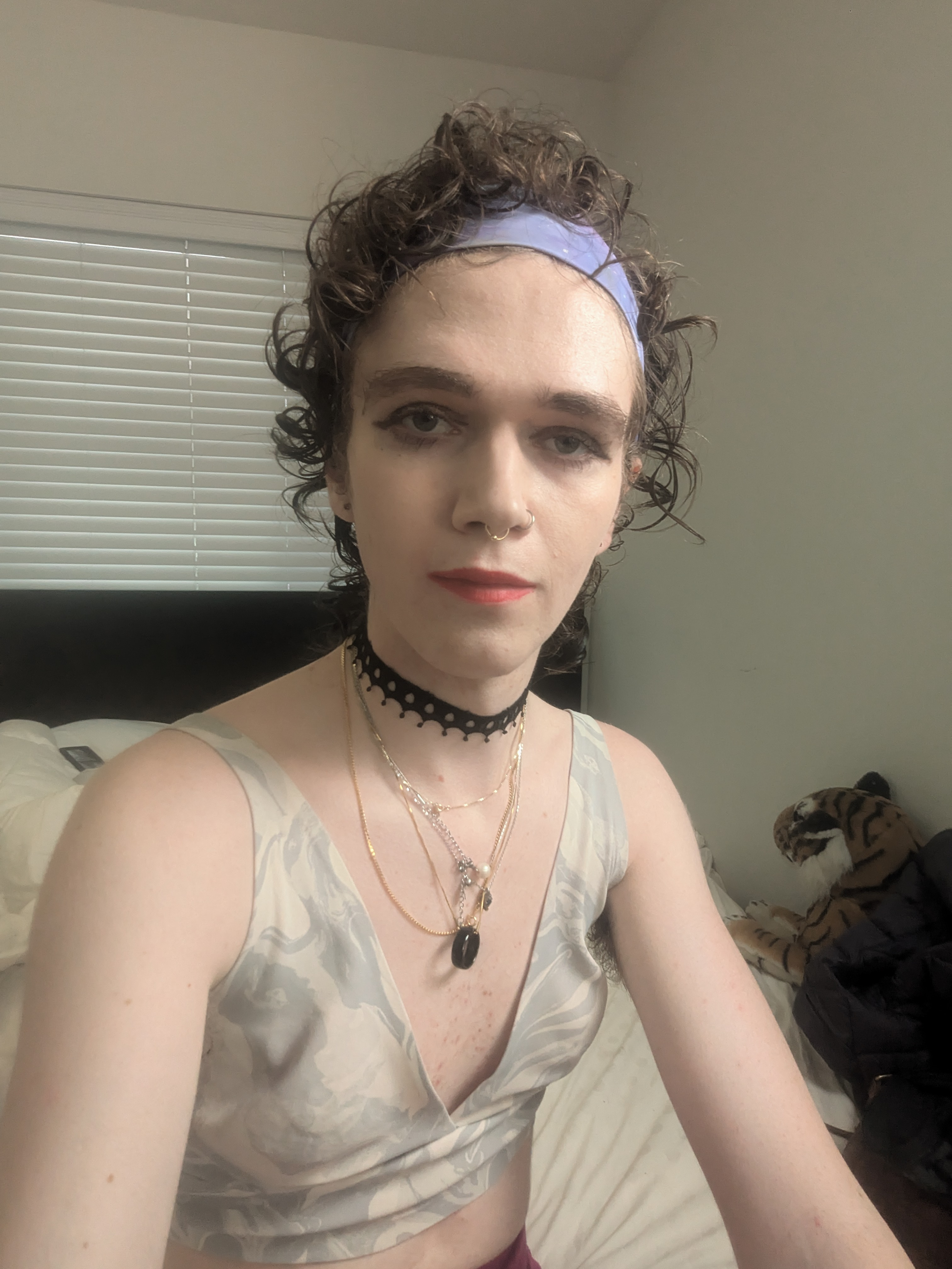 This photo shows a woman with curly hair wearing a light purple... - by Daisy