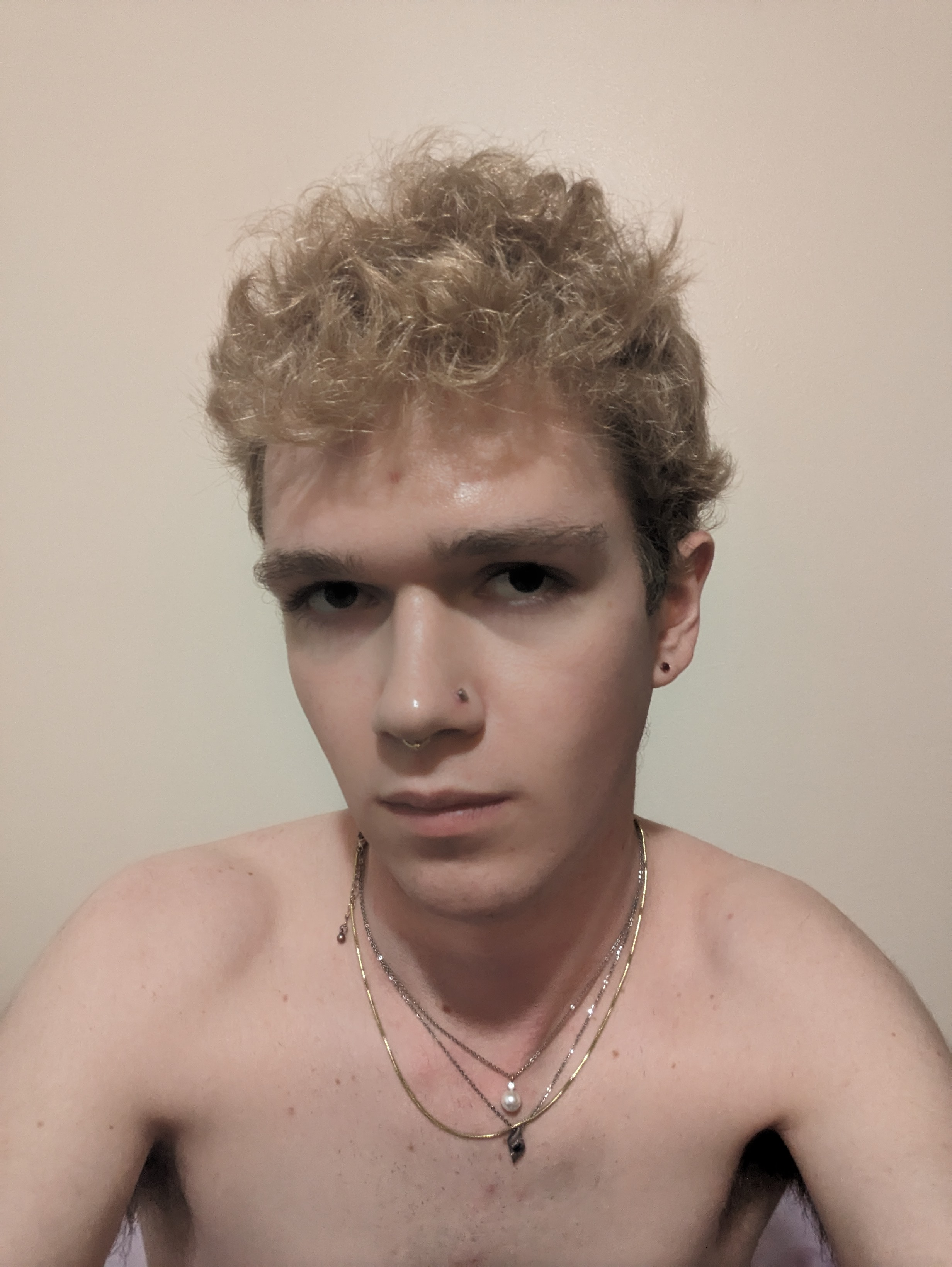 The photo shows a young woman with curly blonde hair taking a... - by Daisy