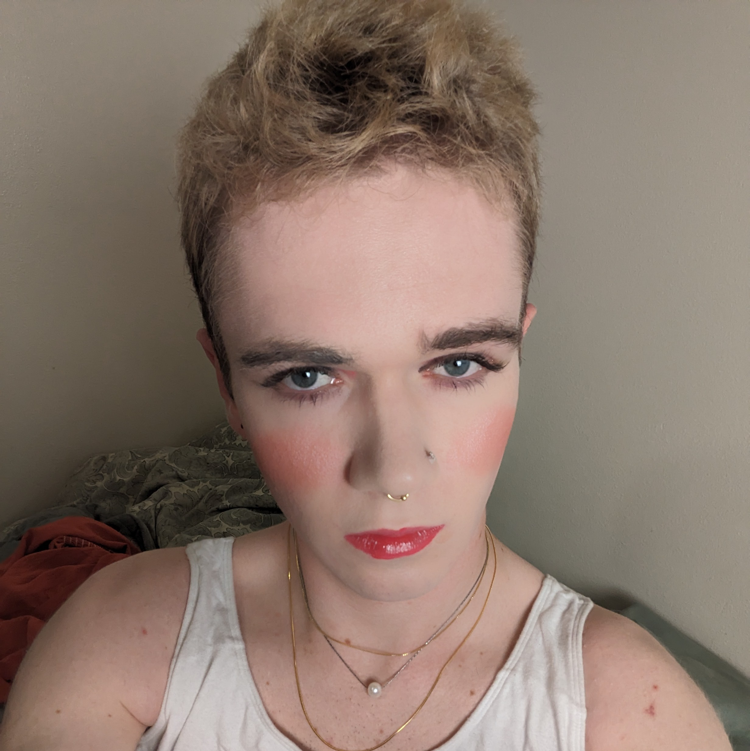 The photo shows a woman with short, light brown hair and blue... - by Daisy