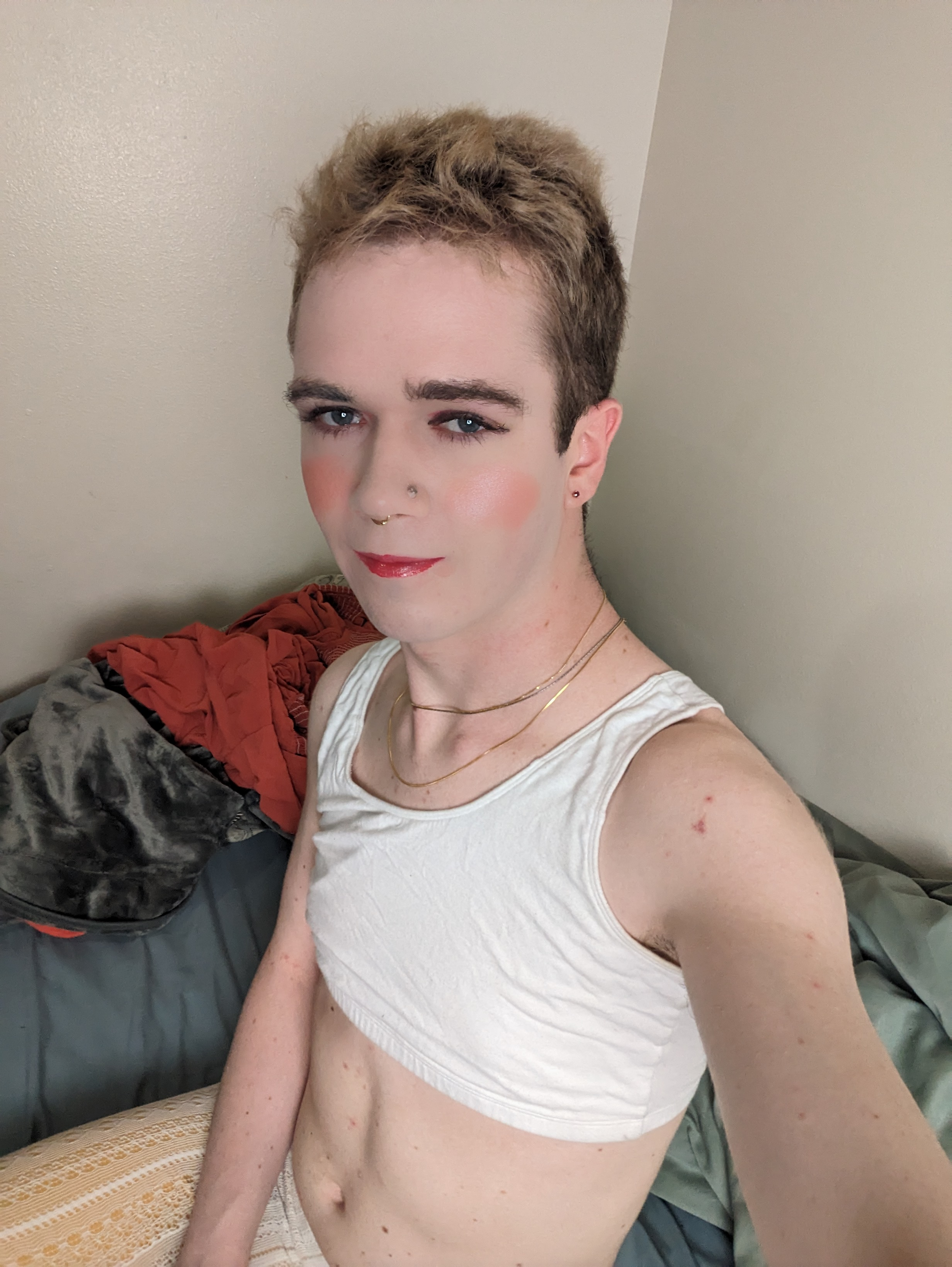 The photo shows a woman with short, light brown hair wearing... - by Daisy