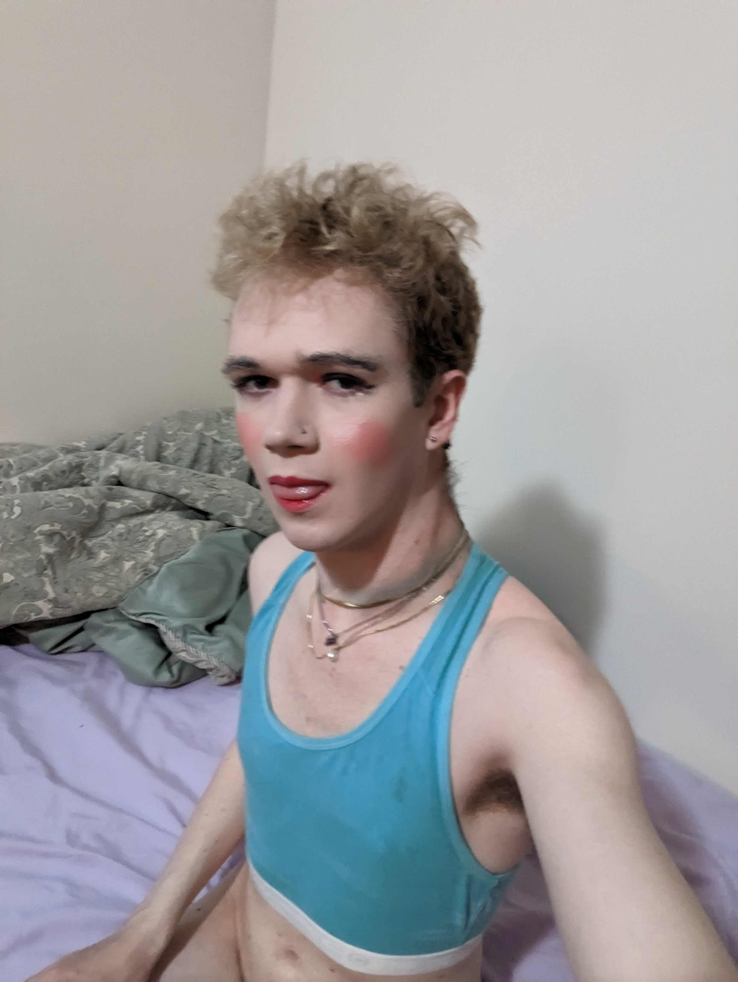 The photo shows a woman with curly, blond hair wearing makeup,... - by Daisy