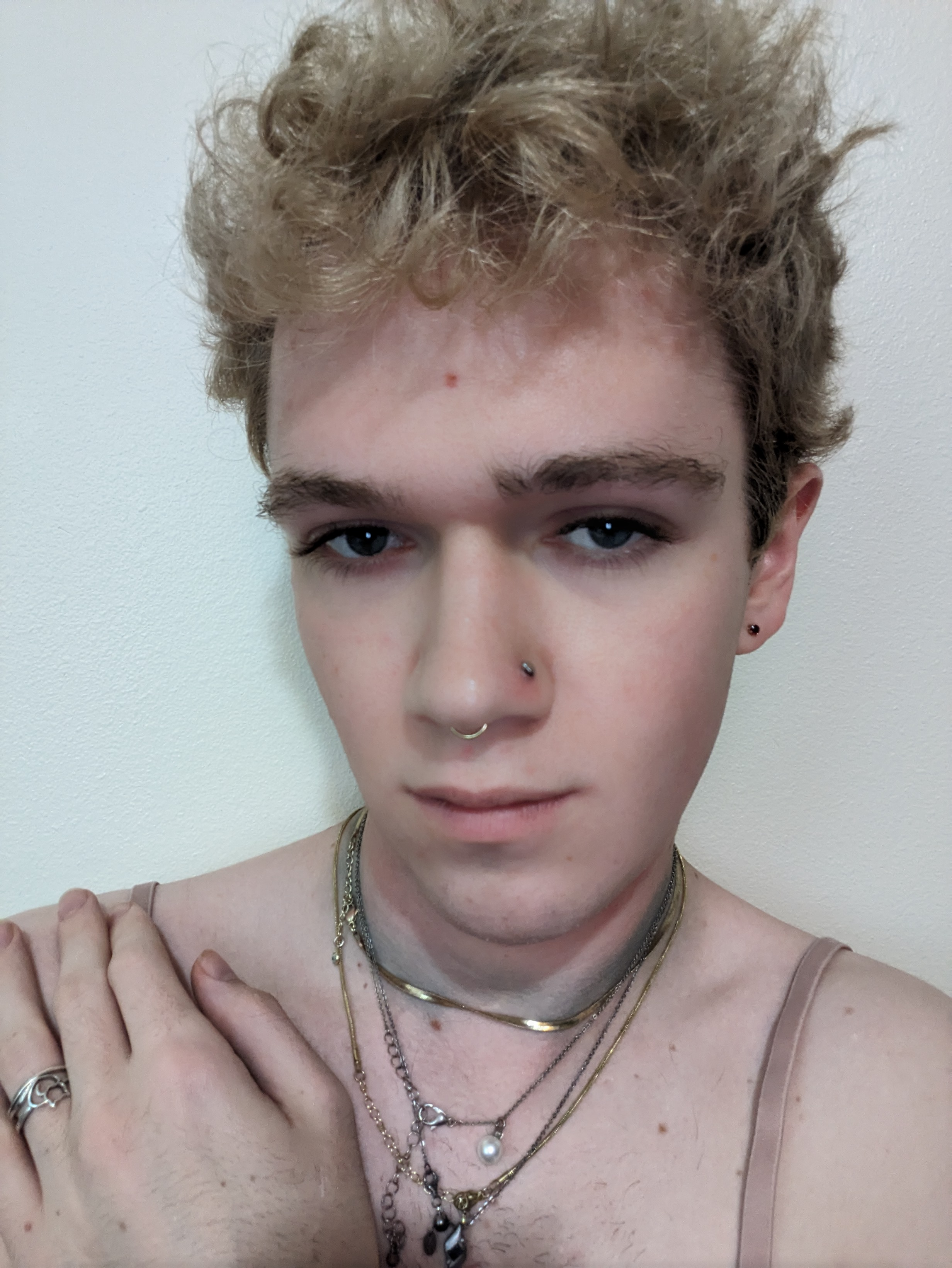 The photo is a close-up selfie of a woman with curly light brown... - by Daisy