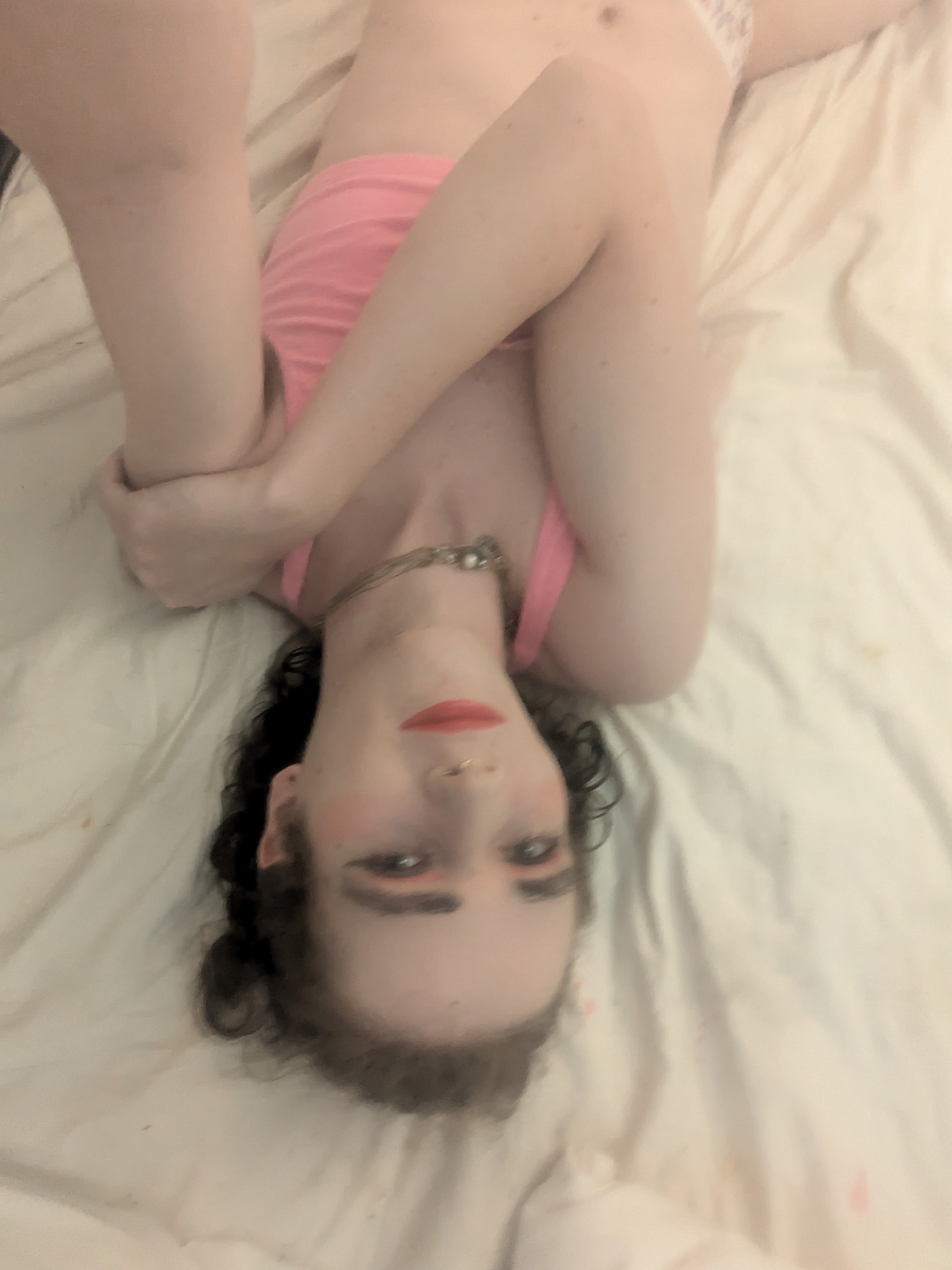 The photo shows a woman lying on a light-colored bed or sheet,... - by Daisy