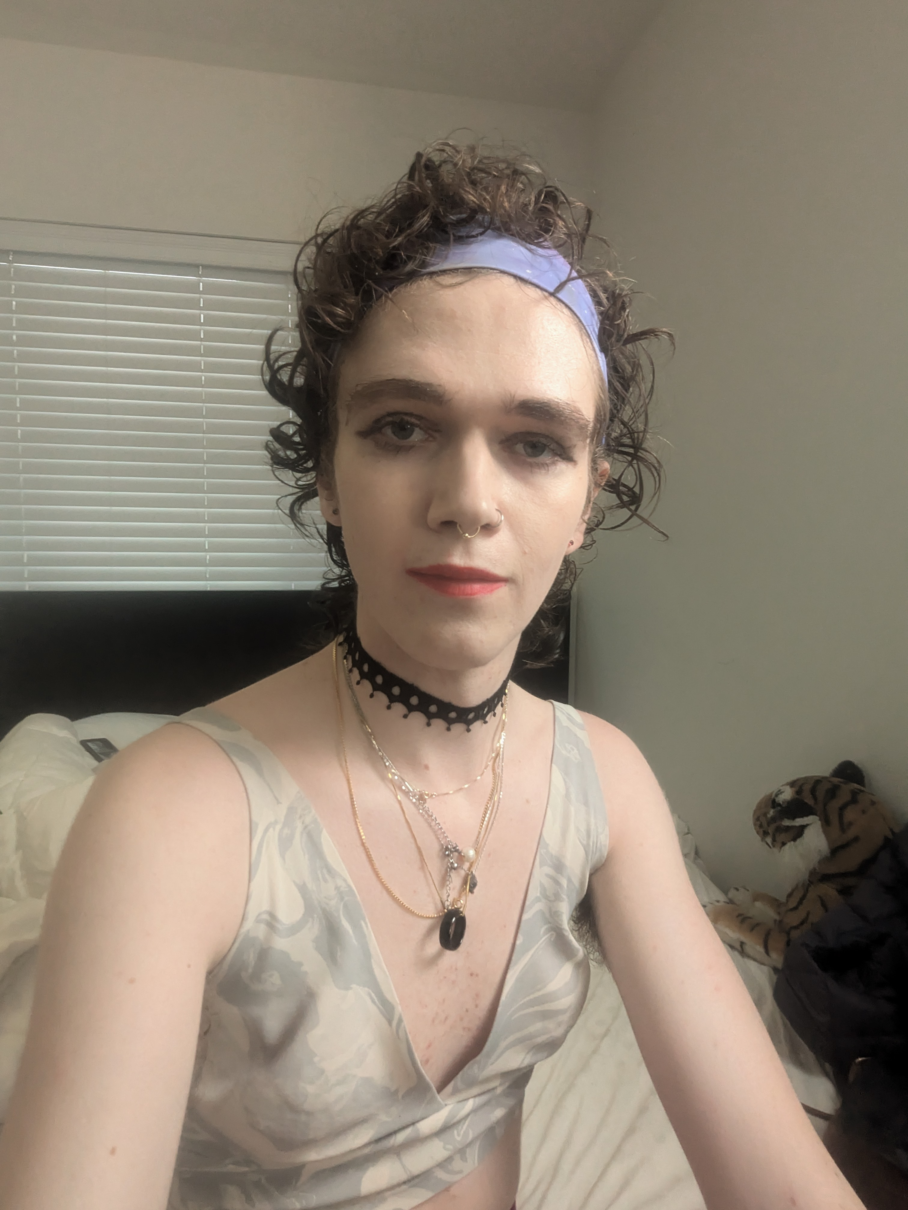 The photo shows a woman with curly hair wearing a light lavender... - by Daisy