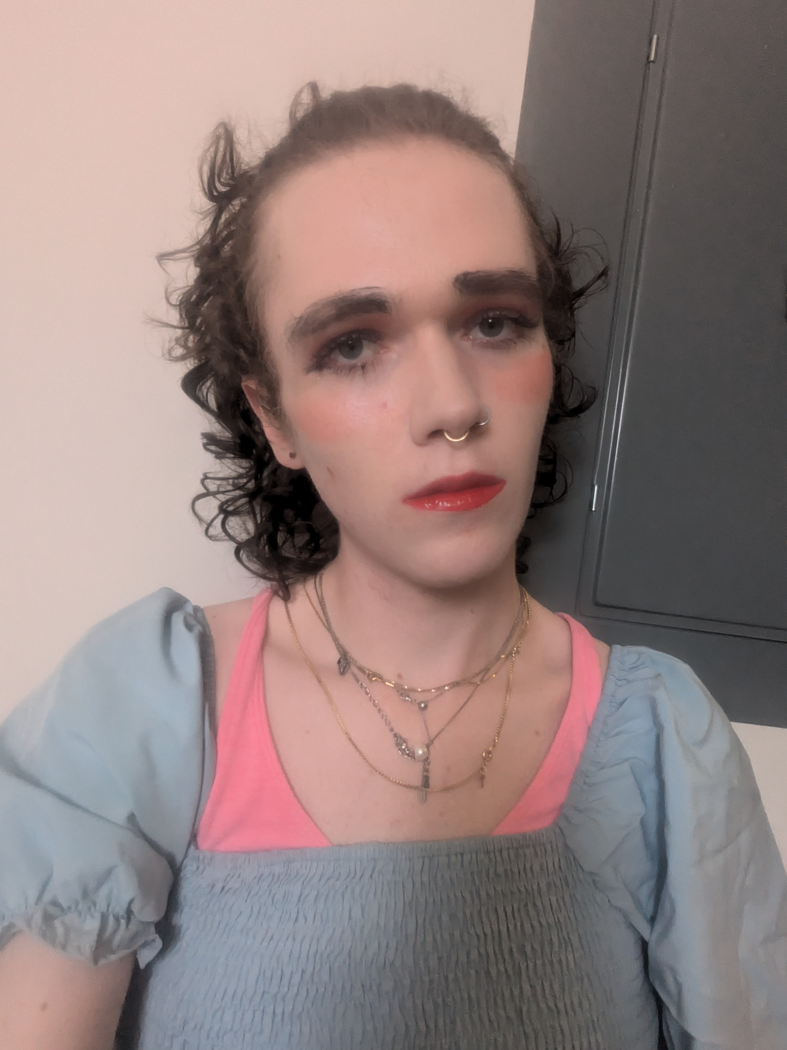 The photo shows a woman with curly brown hair and fair skin. She... - by Daisy